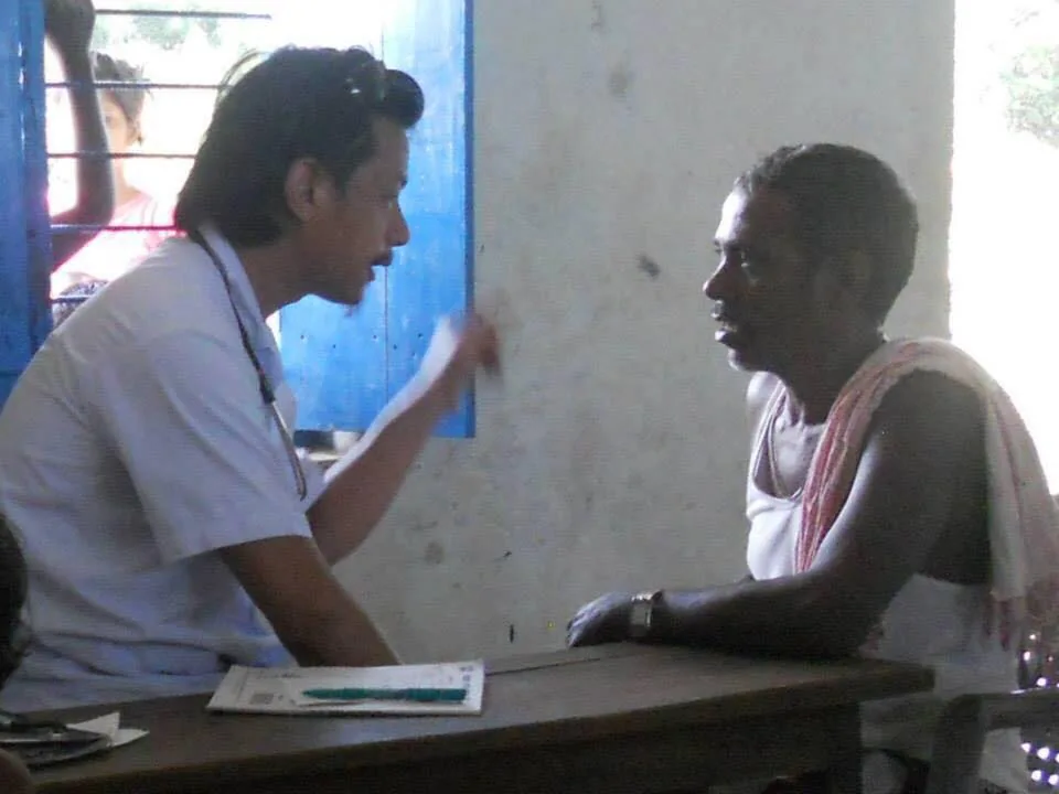 A clinician talks with a patient during a consultation