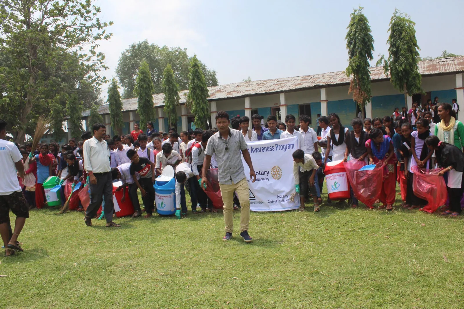 Students and BGSK volunteers together outside a school