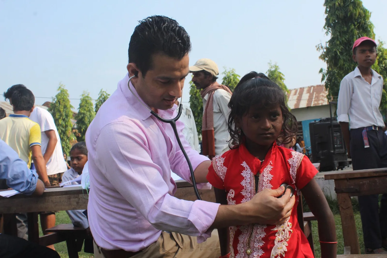 A health worker examines a student at a school program