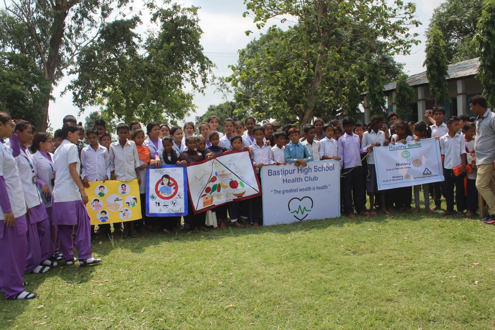 Students stand together with a school health program banner